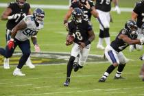 Baltimore Ravens quarterback Lamar Jackson (8) runs with the ball during the second half of an ...