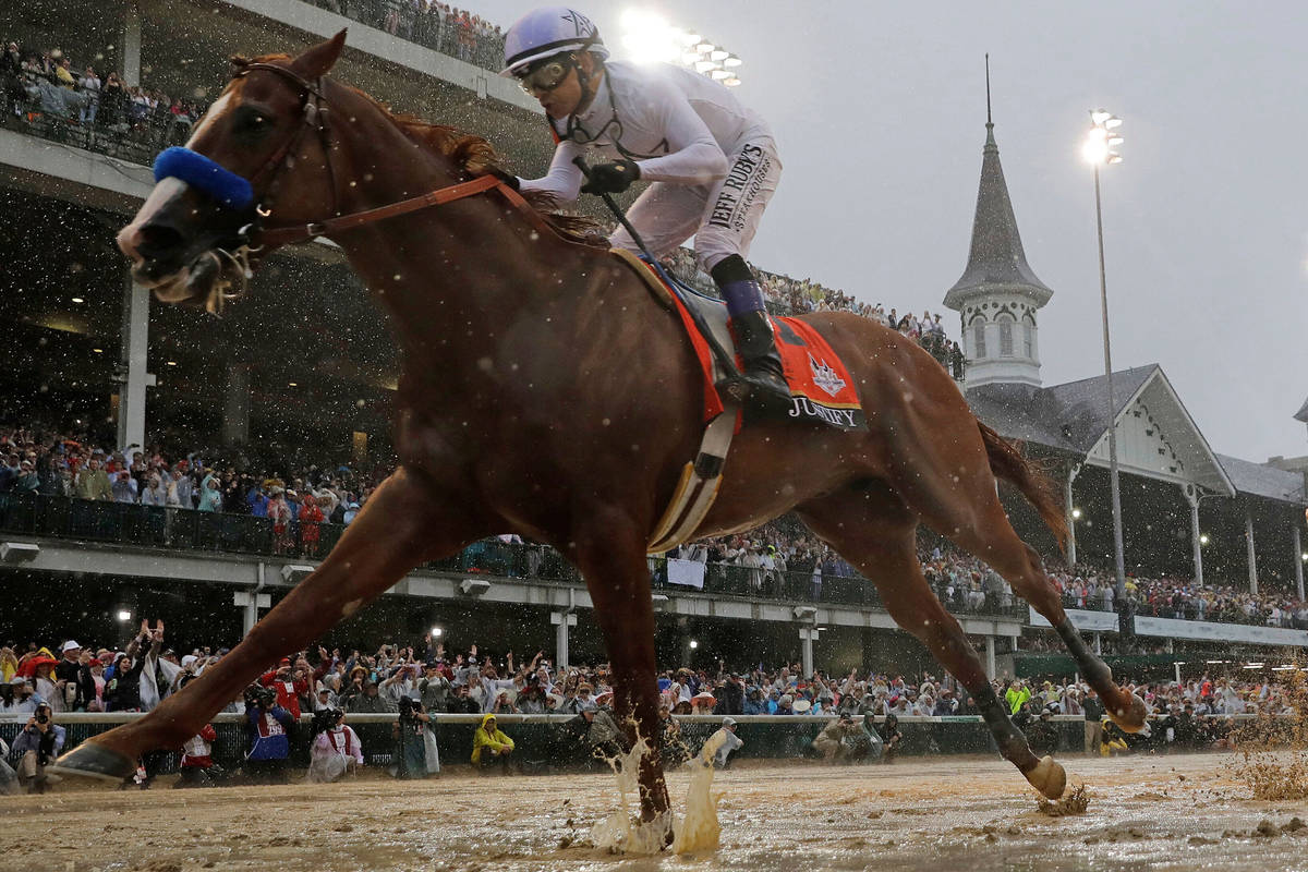 In this May 5, 2018, file photo, Mike Smith rides Justify to victory during the 144th running o ...