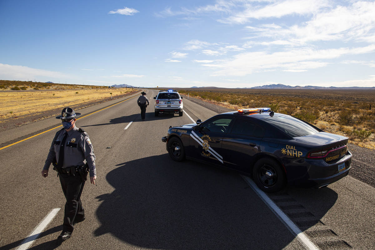 Nevada Highway Patrol troopers respond to the scene of a crash that left five bicyclists dead o ...