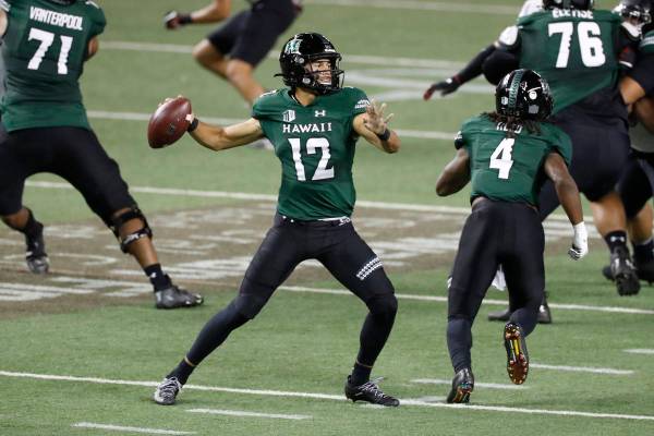 Hawaii quarterback Chevan Cordeiro (12) looks for a receiver during the first half against UNLV ...