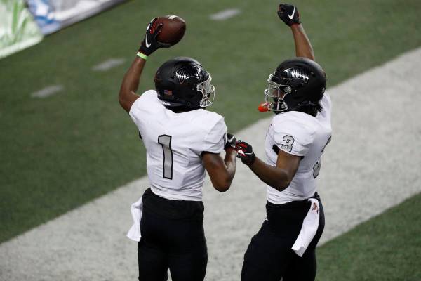 UNLV wide receivers Kyle Williams (1) and Zyell Griffin (3) celebrate in the end zone after Wil ...
