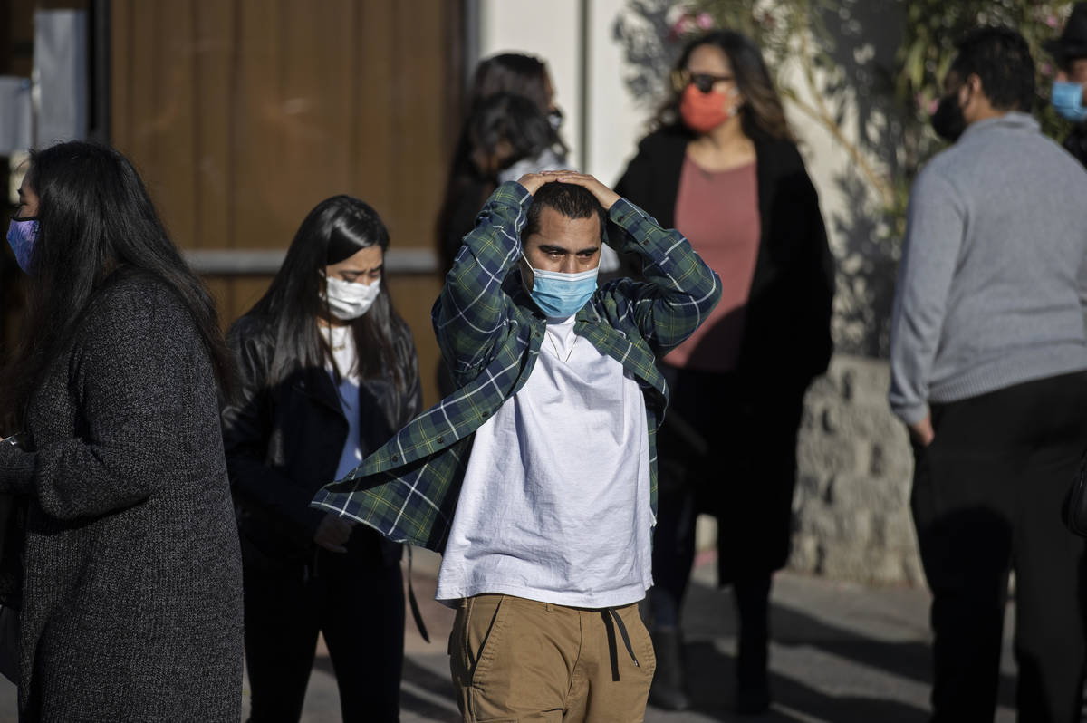 Friends and family grieve outside Hites Funeral Home and Crematory during a memorial service fo ...