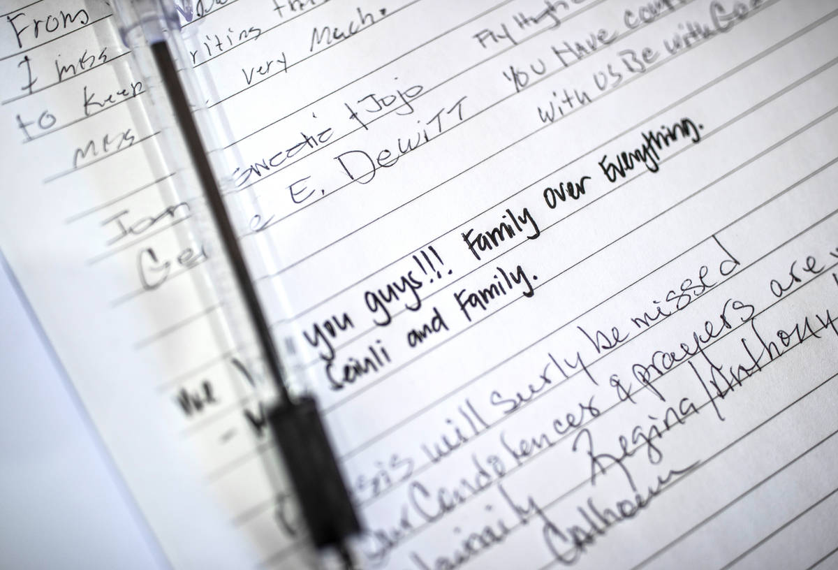 A sign in book at the entrance to a memorial service for Genesis Atkins on Saturday, Dec. 12, 2 ...