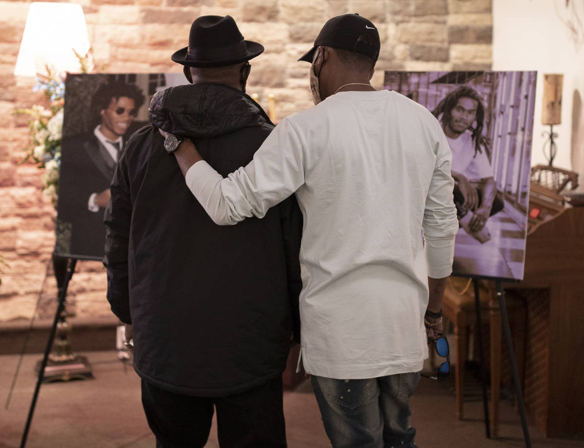 Steve Atkins, left, father of Genesis Atkins, is consoled by a friend during a memorial service ...