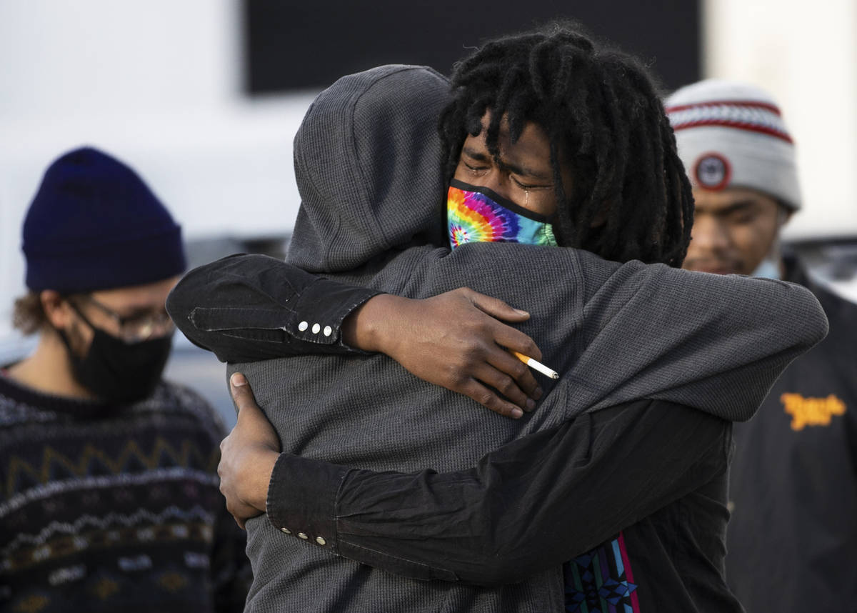 Ace Atkins, middle/facing, brother of Genesis Atkins, is consoled by a friend outside Hites Fun ...