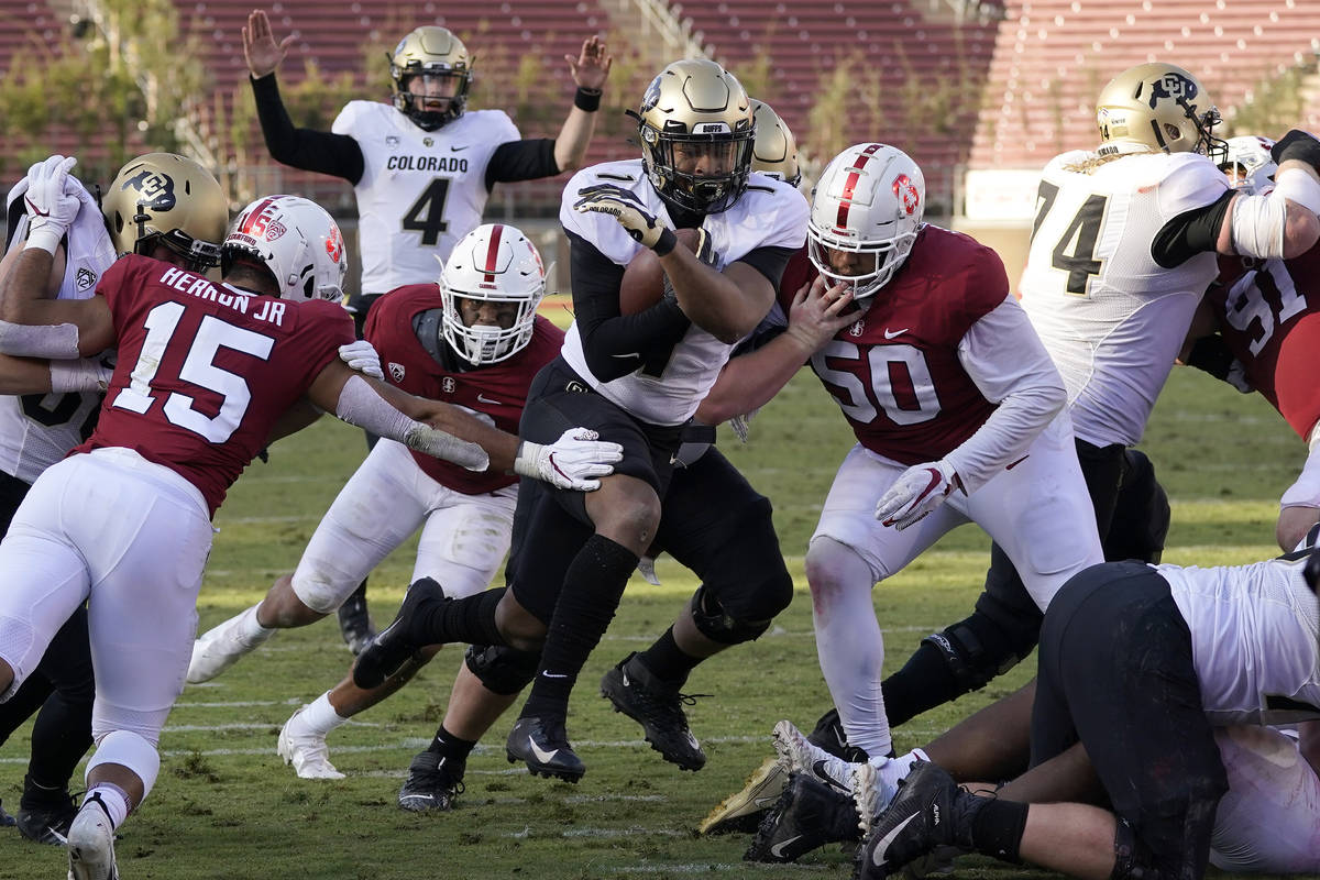 Colorado running back Jaren Mangham, center, runs for a touchdown against Stanford during the s ...
