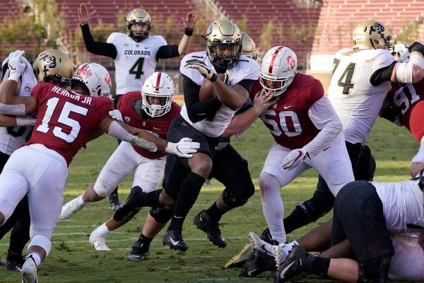 Colorado running back Jaren Mangham, center, runs for a touchdown against Stanford during the s ...