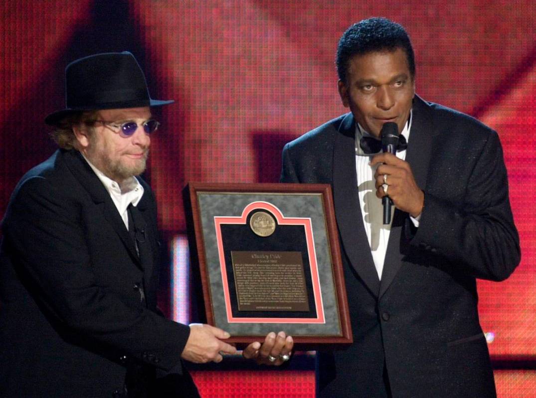 FILE - In this Oct. 4, 2000, file photo, Charlie Pride, right, receives his Country Music Hall ...