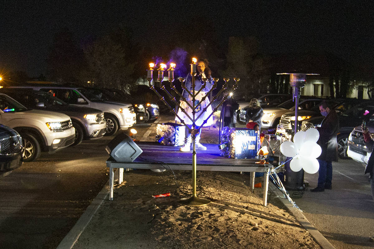 Singer Rinat Hahmigery performs after the menorah was lighted Saturday night at a drive-in Hanu ...