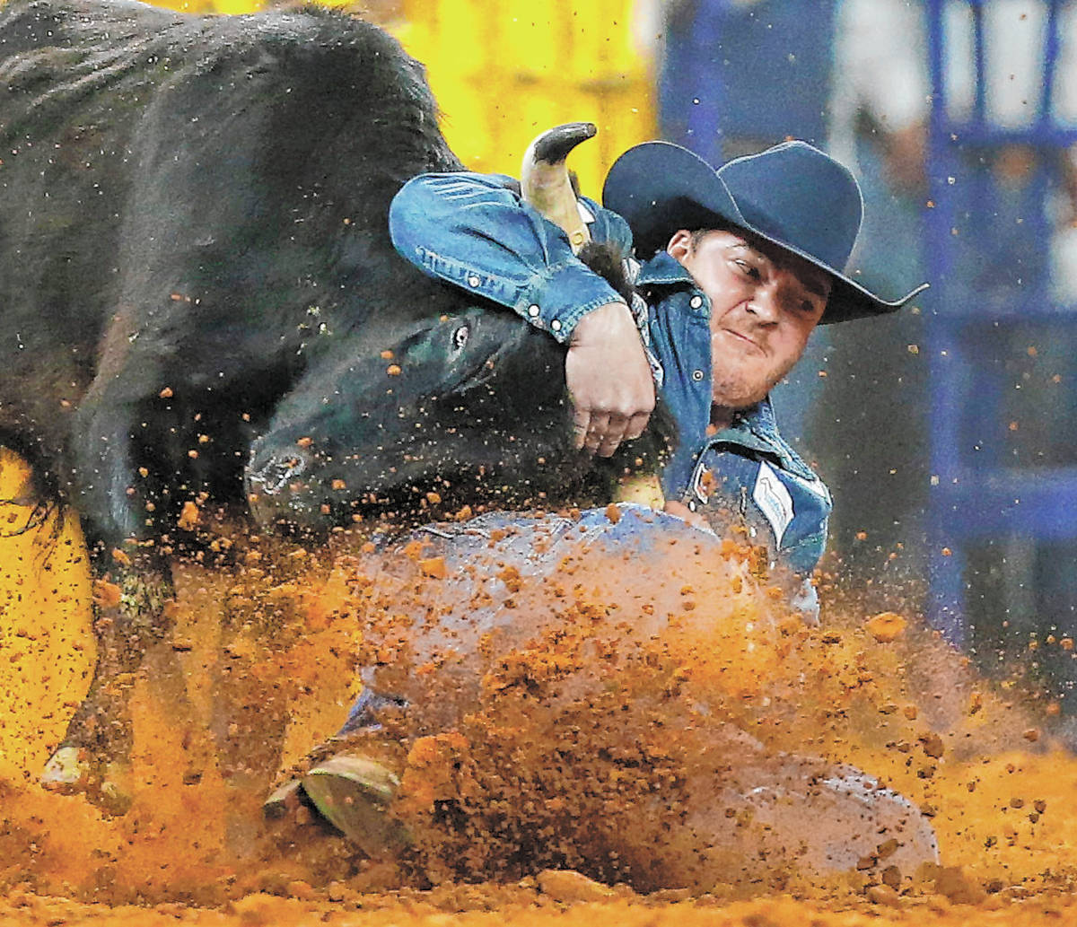 Steer wrestler Jacob Elder competes during Round 10 of the National Finals Rodeo at Globe Life ...