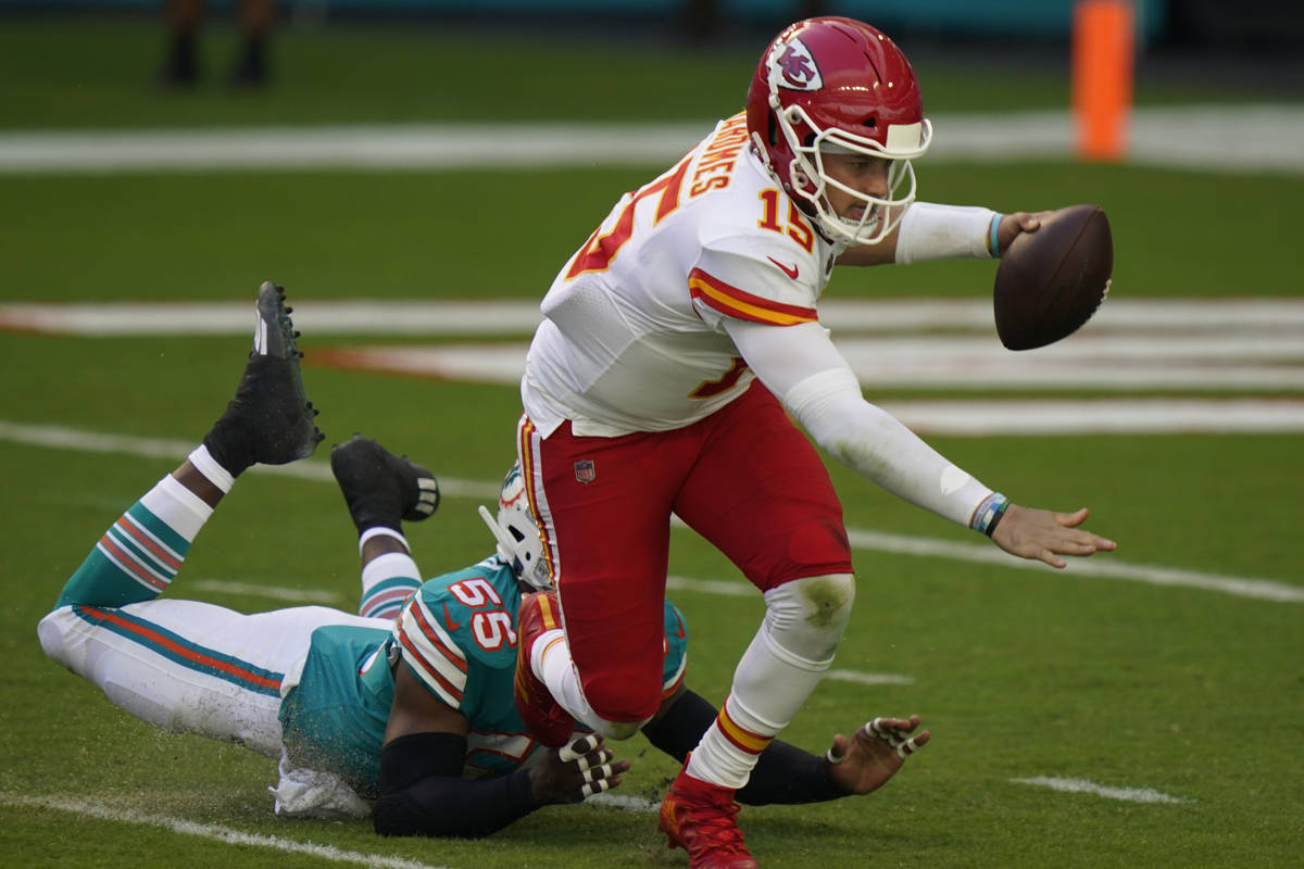 Kansas City Chiefs quarterback Patrick Mahomes (15) falls on the field after he was sacked by M ...