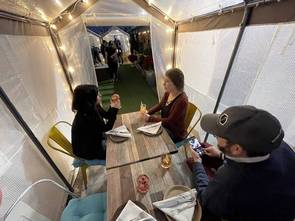 Aubree Toledo, from left, Eric Gladstone and Kerry Callahan in an outdoor individual dinning te ...