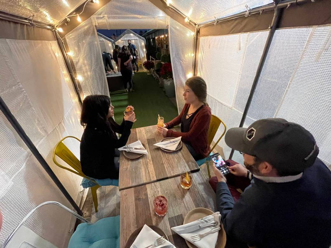 Aubree Toledo, from left, Eric Gladstone and Kerry Callahan in an outdoor individual dinning te ...