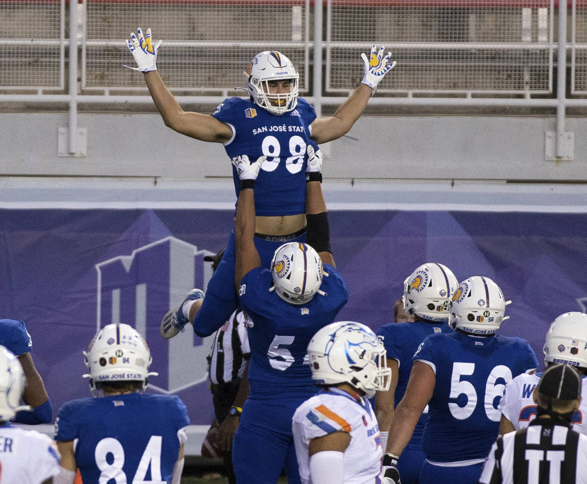 San Jose State tight end Sam Olson (88) leaps into the arms of a teammate after scoring a two-p ...
