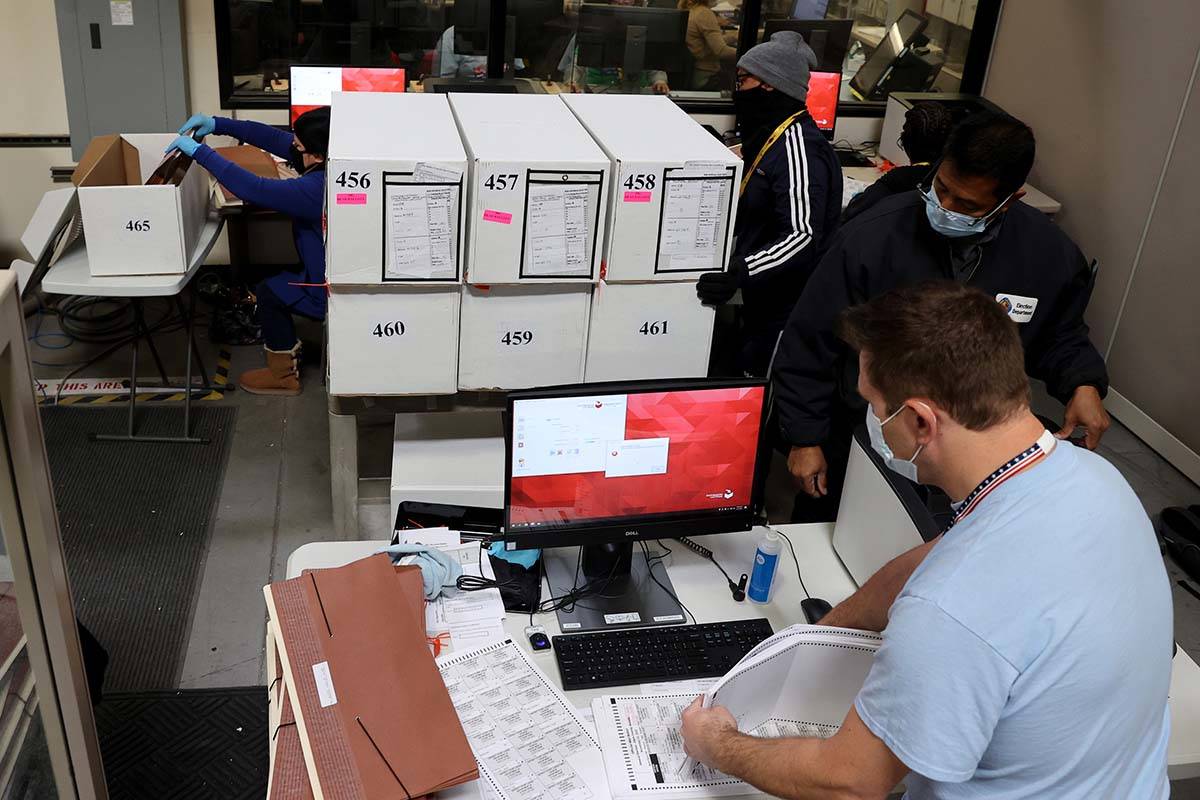 County Election Department staff work on the recount in the Commission District C race between ...