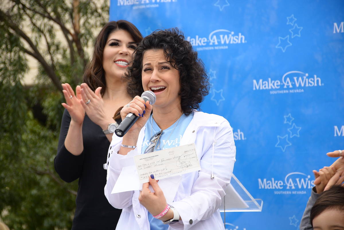 Make-A-Wish Southern Nevada President and CEO Caroline Ciocca reacts to a$100,000 check from Cr ...
