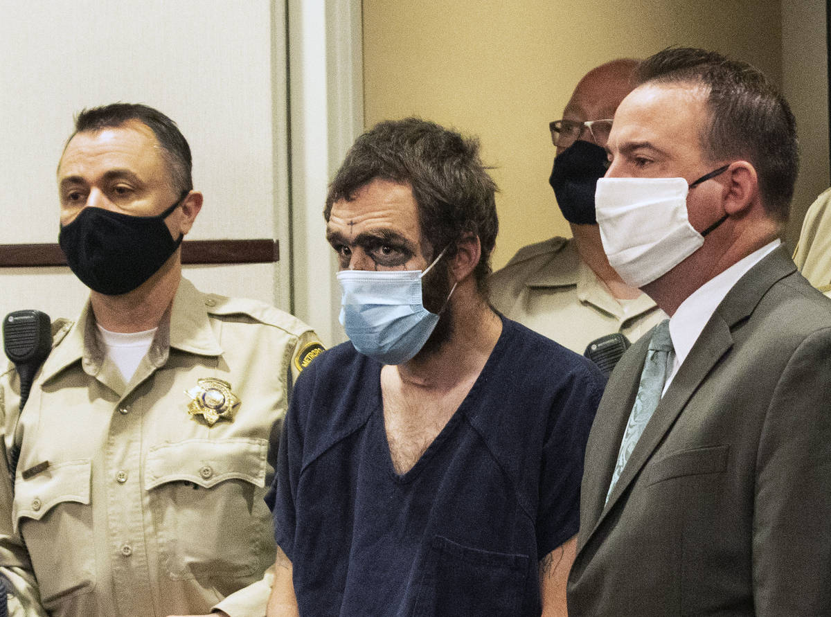 Christopher McDonnell, center, one of three people charged in a shooting spree in Henderson and ...