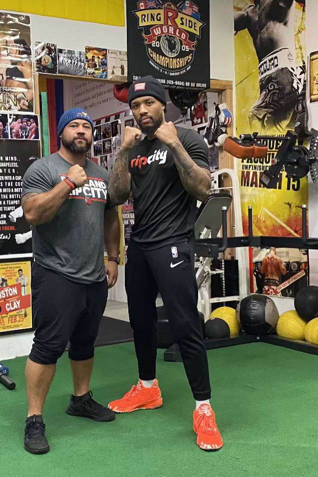 Portland Trailblazers point guard Damian Lillard poses for a photo with his boxing trainer, Cem ...