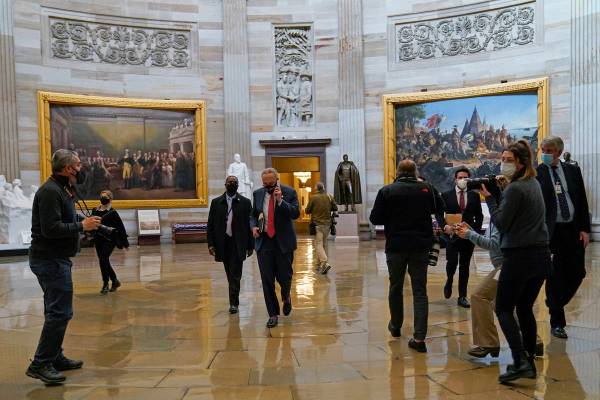 Senate Minority Leader Sen. Chuck Schumer of N.Y., walks past reporters on Capitol Hill in Wash ...