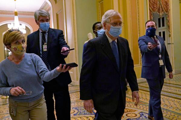 Senate Majority Leader Mitch McConnell of Ky., walks past reporters on Capitol Hill in Washingt ...