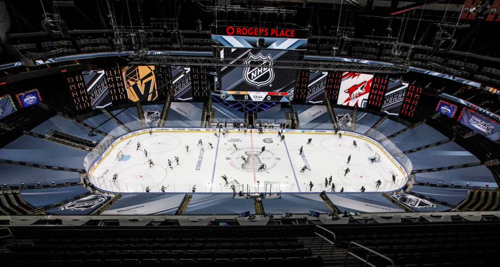 Arizona Coyotes and Vegas Golden Knights players warm up for an NHL hockey exhibition game in E ...