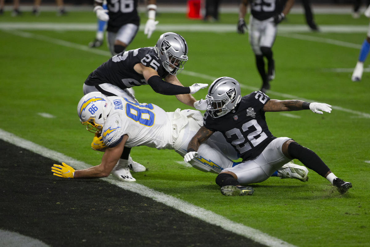 Los Angeles Chargers tight end Hunter Henry (86) dives into the end zone past Raiders free safe ...