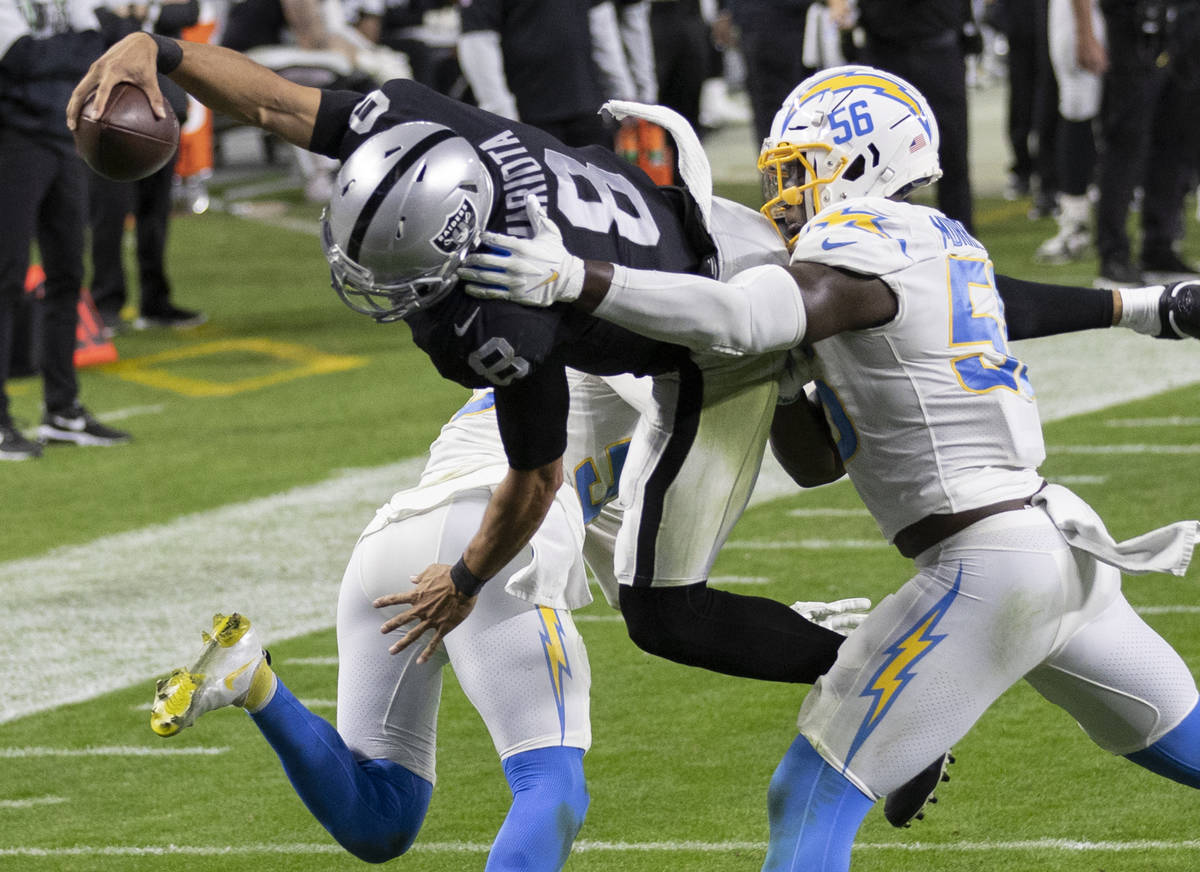 Raiders wide receiver Siaosi Mariner (9) leaps over Los Angeles Chargers outside linebacker Ken ...