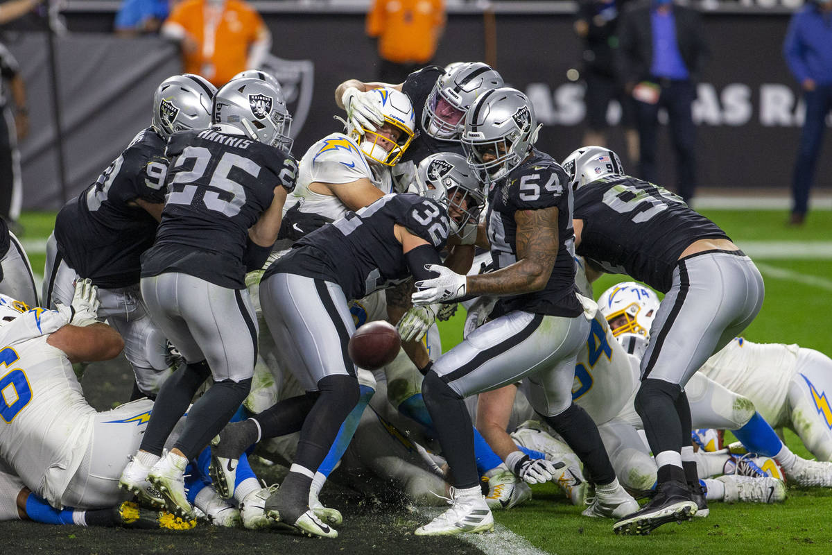 Los Angeles Chargers quarterback Justin Herbert (10) fumbles as he is hit by Raiders inside lin ...