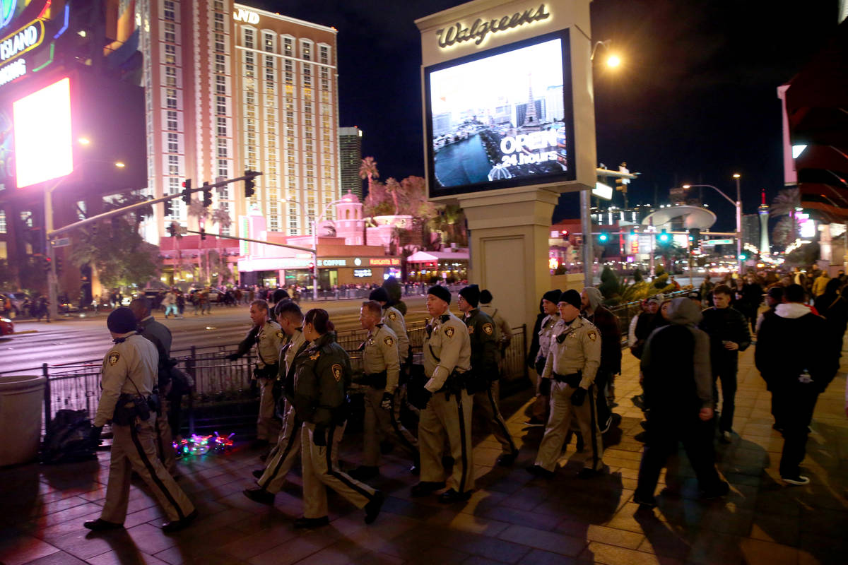 Las Vegas police officers walk on the north Strip on New Year's Eve on Dec. 31, 2018. (K.M. Can ...