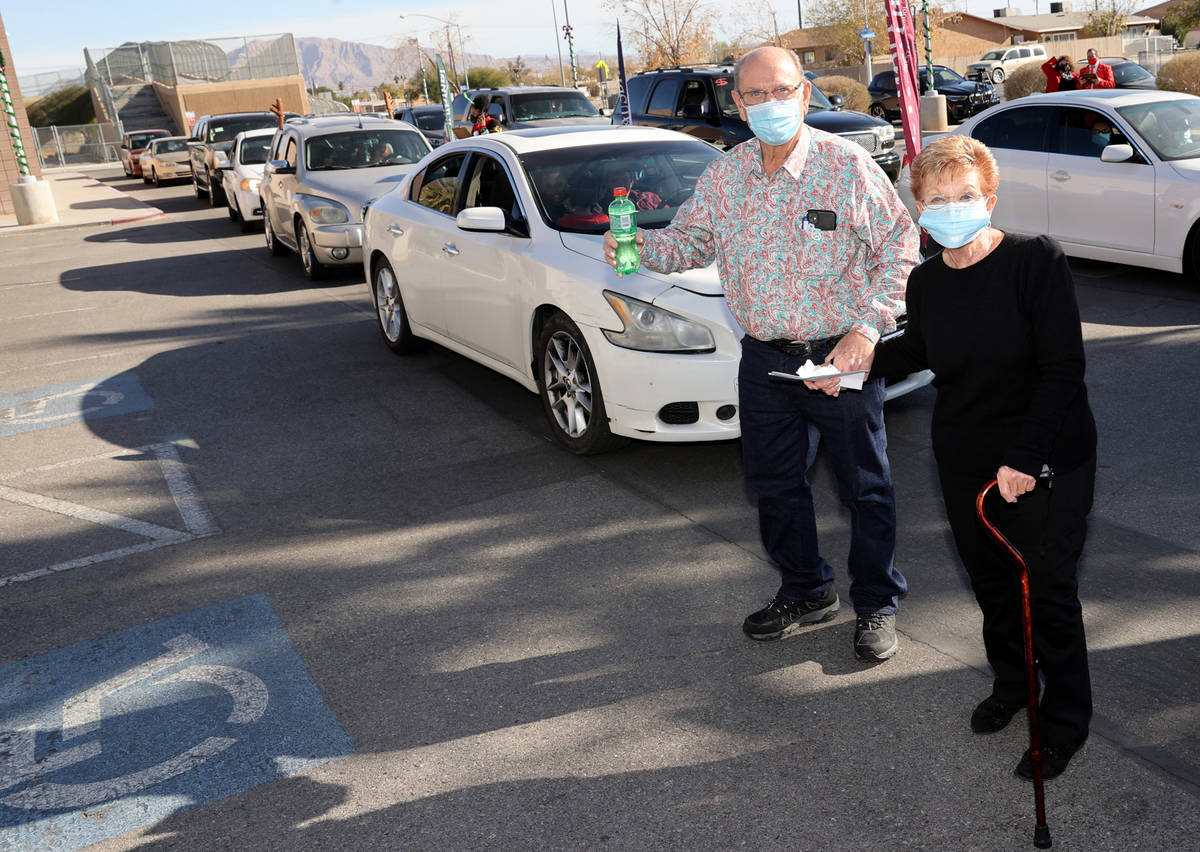 Robert and Sandy Ellis arrive for their drive-thru toy and shoes giveaway at Martinez Elementar ...