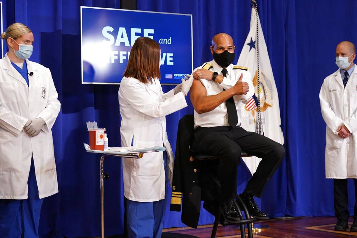 U.S. Surgeon General Jerome Adams receives a Pfizer-BioNTech COVID-19 vaccine shot at the Eisen ...