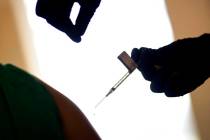 In a Tuesday, Dec. 15, 2020, file photo, a droplet falls from a syringe after a health care wor ...
