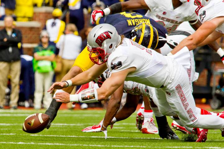 UNLV quarterback Blake Decker (5) recovers his own fumble in the first quarter of an NCAA colle ...