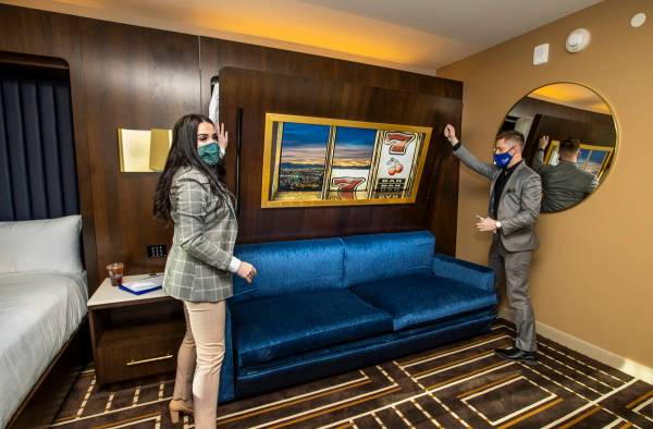 Media Relations Alex Hurley, left, and Hotel Supervisor Trent Becker lower a second bed availab ...