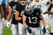 Las Vegas Raiders wide receiver Hunter Renfrow #13 is helped off the field after suffering a bi ...