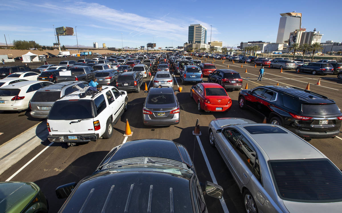 Hundreds of drivers and passengers wait in the World Market parking lot as the Las Vegas Rescue ...