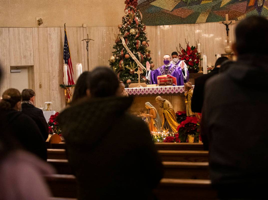 Father Miguel Corral addresses the congregation during Mass at St. Anne's Catholic Church in La ...