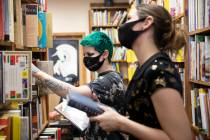 Friends Mercury Taft, left, and Stephanie Lehr, right, shop for books at Amber Unicorn Books. T ...