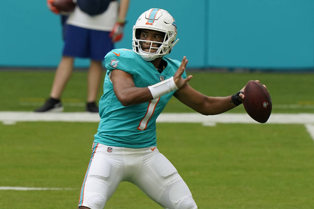 Miami Dolphins quarterback Tua Tagovailoa (1) looks to pass the football during the first half ...