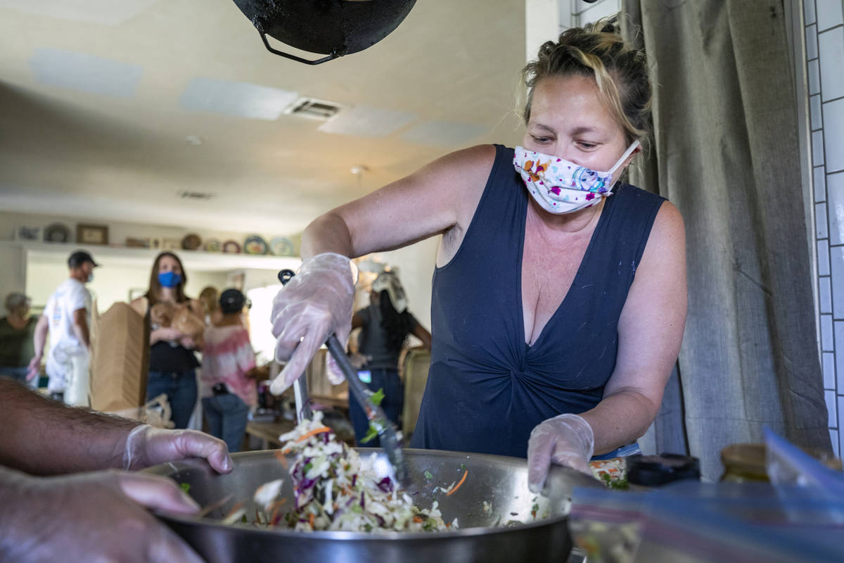 Kim Foster, writer and organizer of the Please Send Noodles cookbook club, prepares coleslaw fo ...