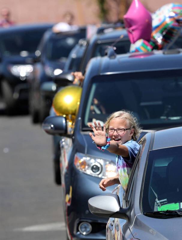 Skyler Milner, 11, a fifth grader at Legacy Traditional School Southwest waves during an apprec ...