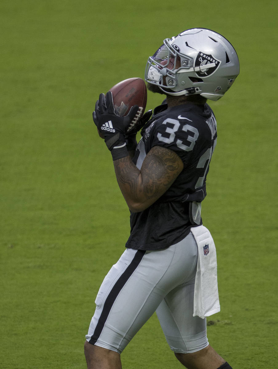 Las Vegas Raiders running back Lynn Bowden Jr. (33) secures a pass while warming up during a fo ...