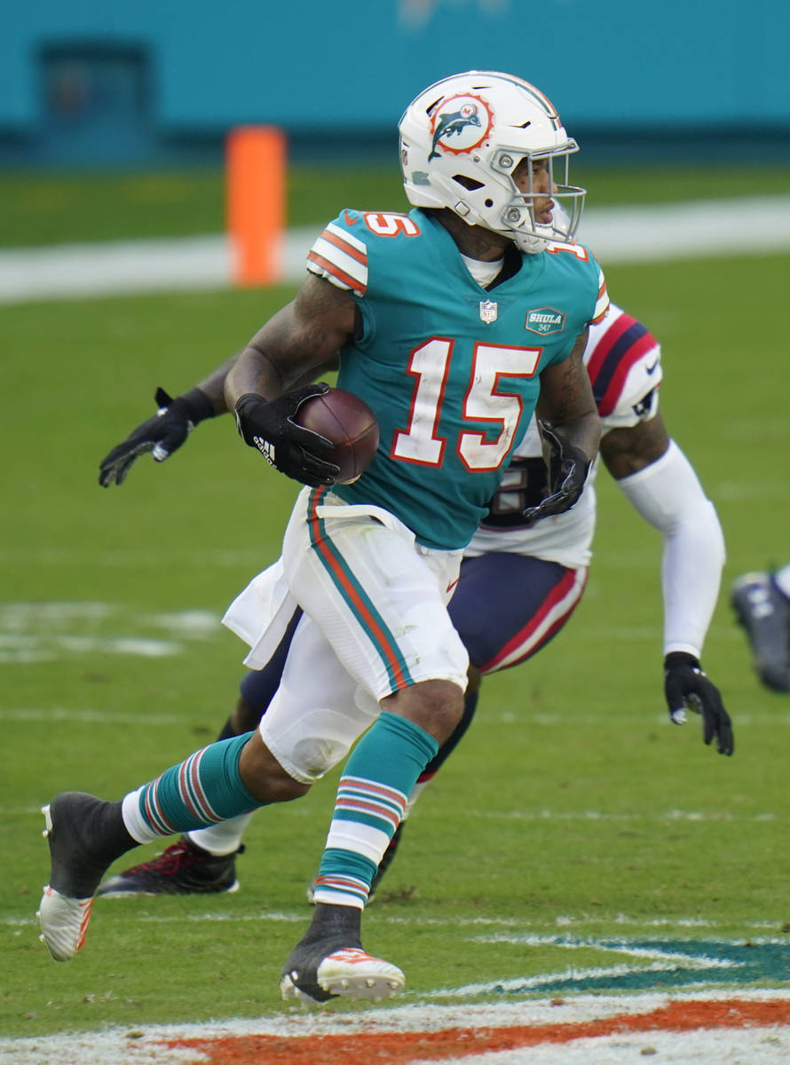 Miami Dolphins running back Lynn Bowden (15) runs after a trick play during an NFL football gam ...