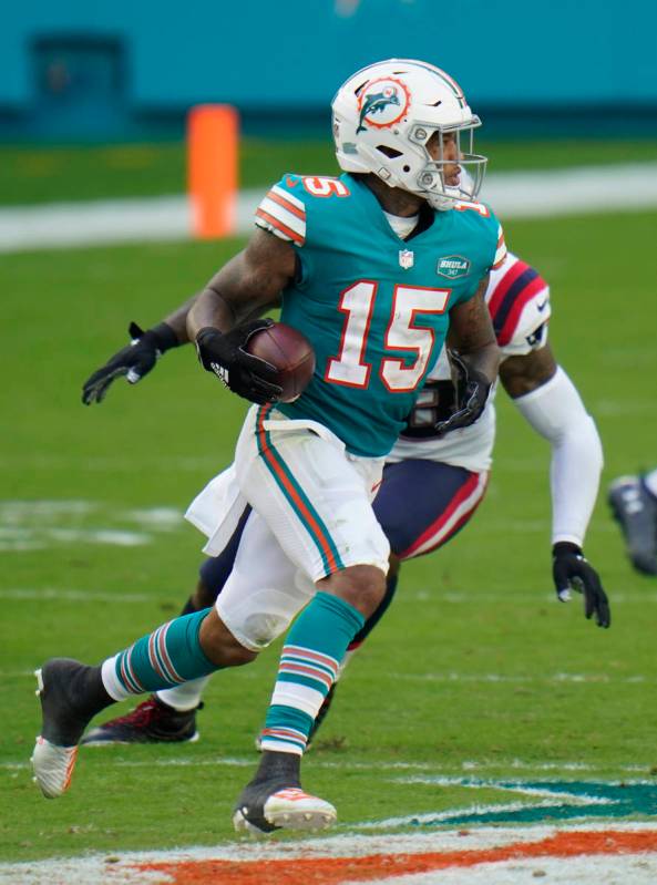 Miami Dolphins running back Lynn Bowden (15) runs after a trick play during an NFL football gam ...