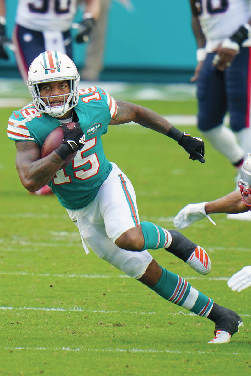 Miami Dolphins running back Lynn Bowden (15) runs the football during the first half of an NFL ...