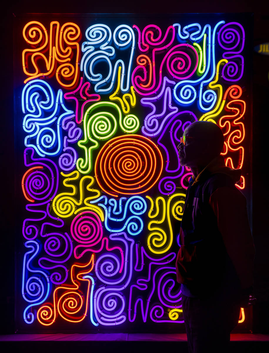 Neon Museum 2020 Artist in Residence Victor Ehikhamenor silhouetted by his piece "Harvesti ...