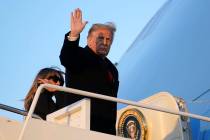 President Donald Trump waves as he boards Air Force One at Andrews Air Force Base, Md., Wednesd ...