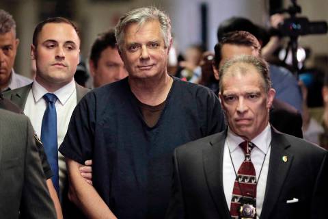 In this June 27, 2019 file photo, Paul Manafort, center, arrives at court in New York. (AP Pho ...