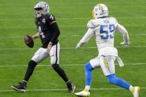 Raiders quarterback Derek Carr (4) winces in pain as he scramble towards the sideline with Los ...
