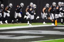 The Raiders take the field in the first quarter during an NFL football game on Thursday, Dec. 1 ...